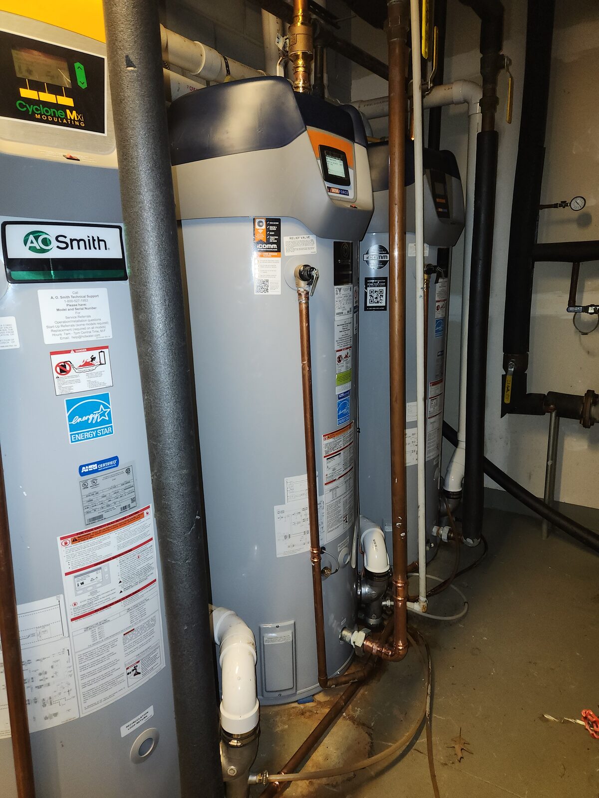 Installed residential water heater with connected supply and drain lines