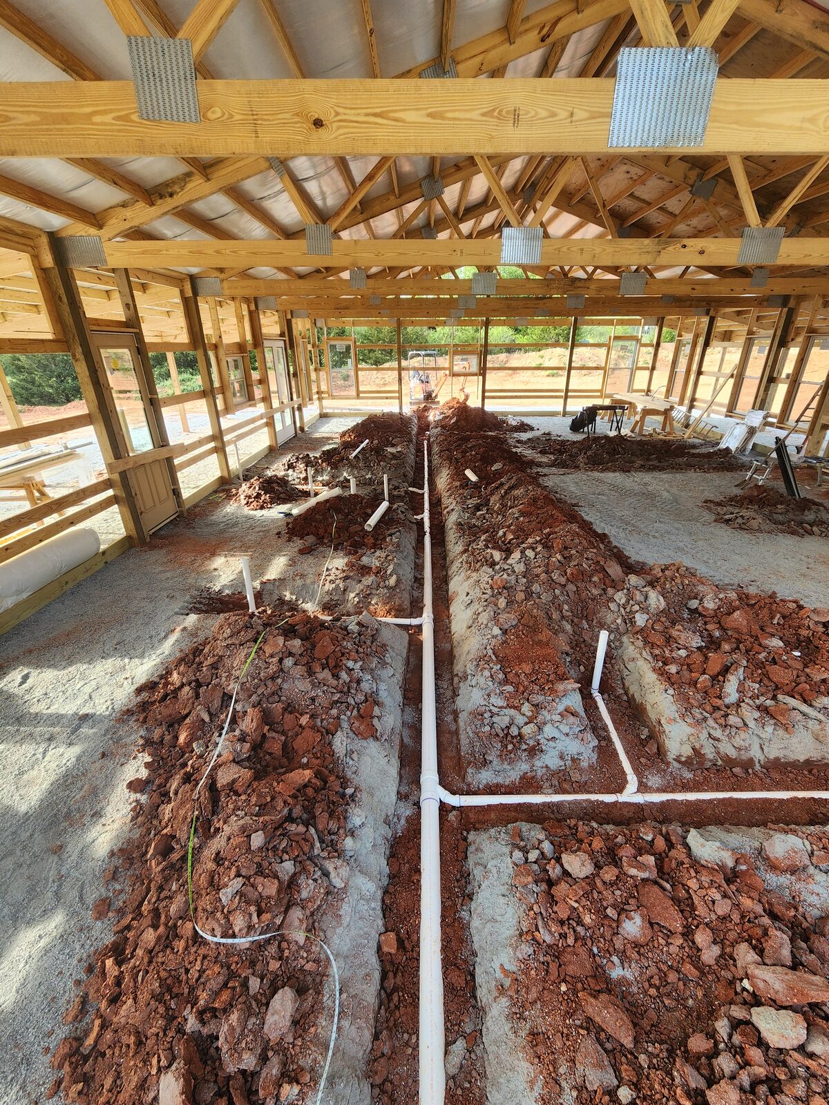 Underground plumbing installed through red clay at an H3 Plumbing job site